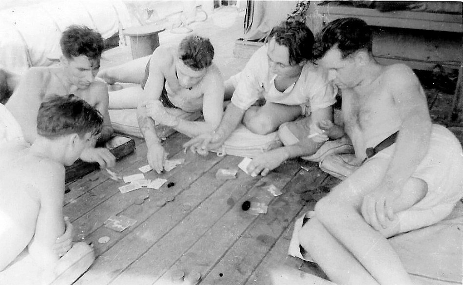 Royal Canadian Navy : crew members playing cards in tropics,  HMCS Minas, 1941