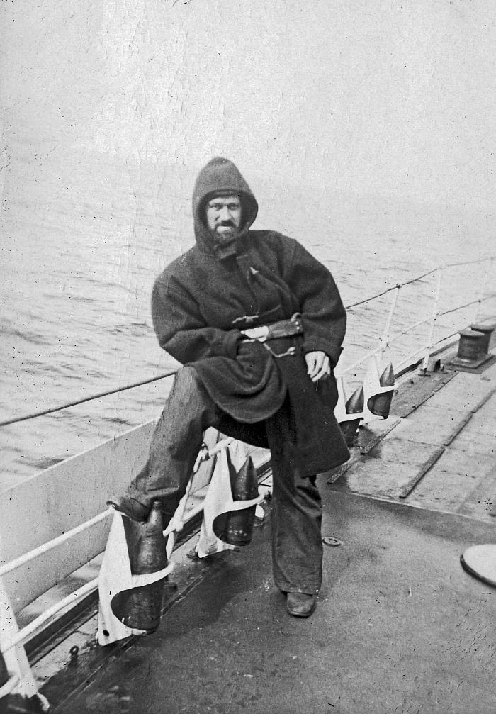 Fred Hollands in greatcoat on upper deck of HMCS Skeena