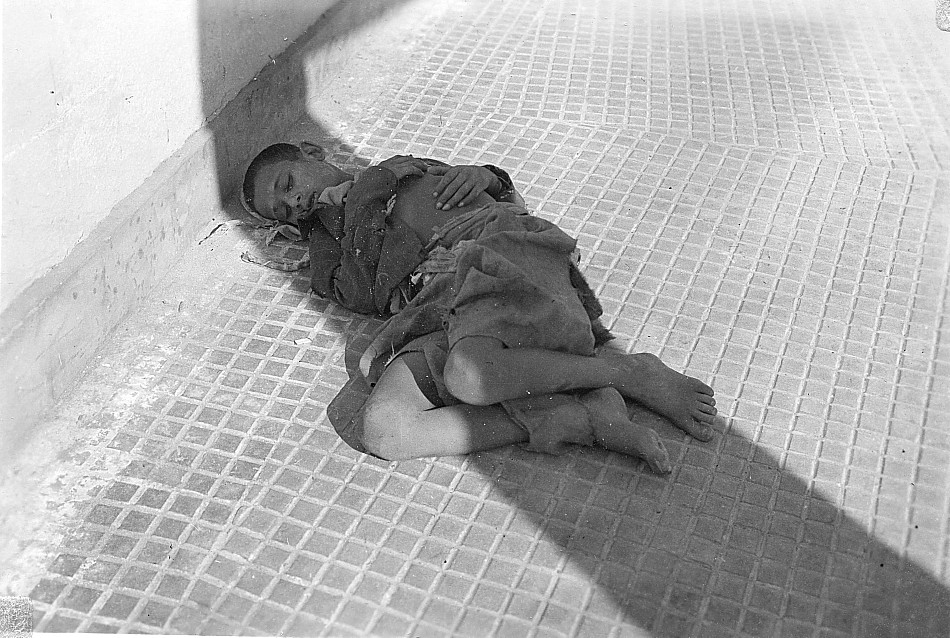 Boy sleeping on a street, Possibly, Alexandria, Egypt, 1945.