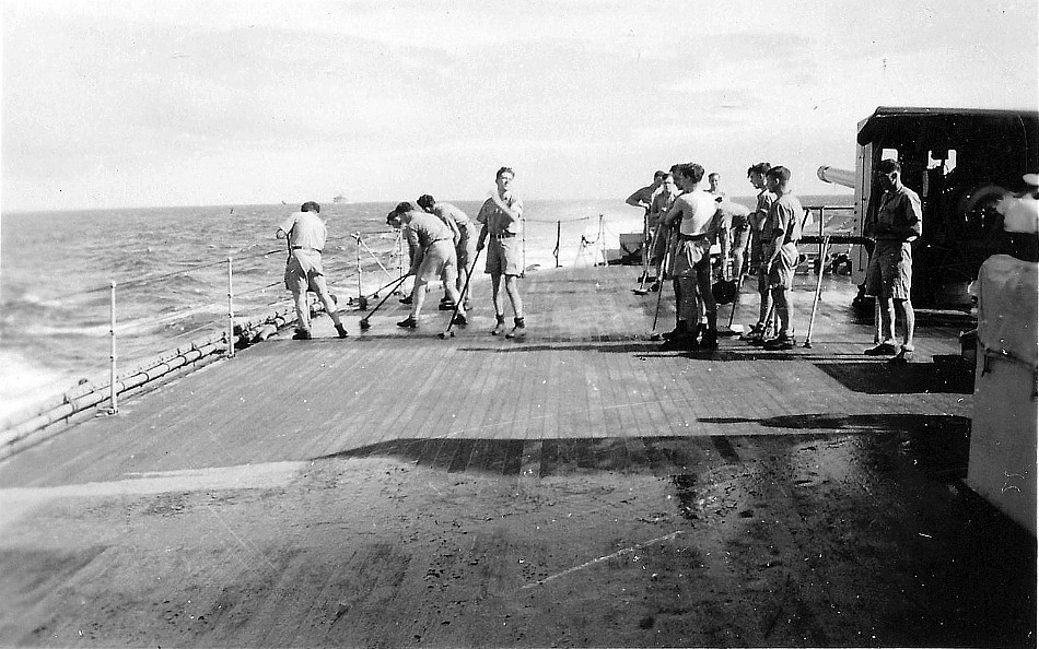 Royal Canadian Navy : Holystoning the deck on HMCS Prince Robert.